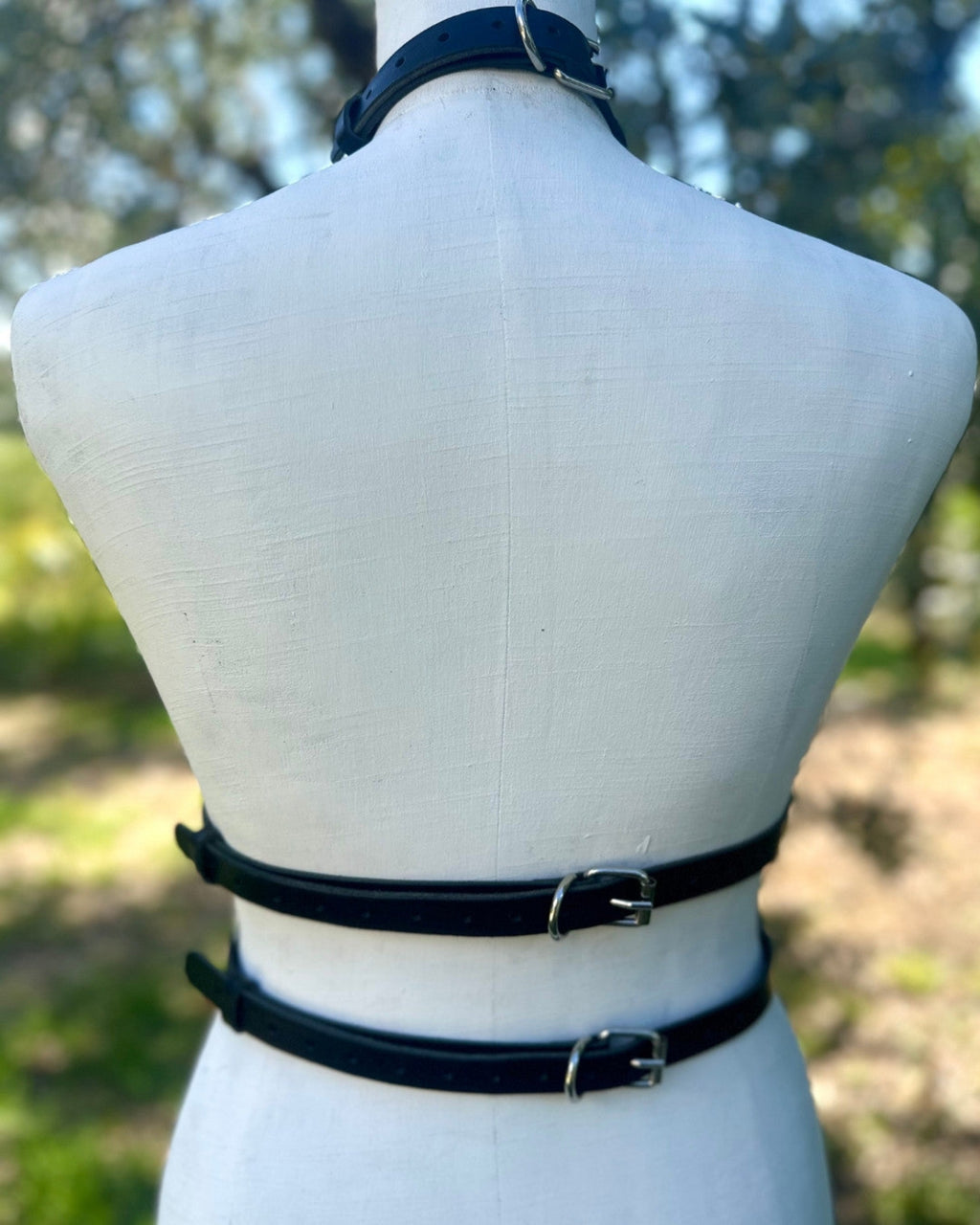 Minimalistisches Lederaccessoire mit Doppelgurt  und silbernen Schnallen, Ansicht von hinten an einer Puppe – XMORENIUM-NERO 